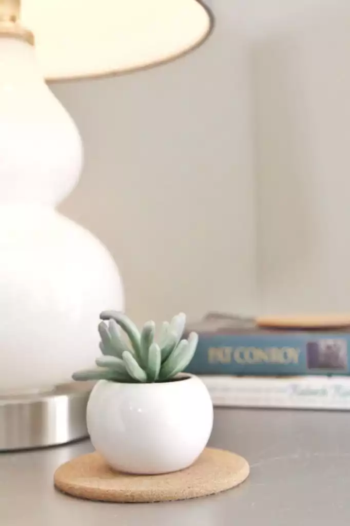 Bedside detail with lamp and fresh flowers